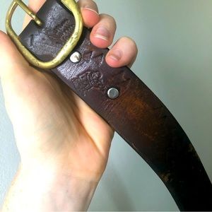 Leather belt with hunter, turkey, deer and tree stamps.